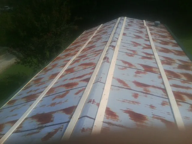 Rusted metal roof panels with new wood purlins before replacement — Storm Damage Roof Repair in Warden by Roofing Brothers
